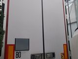 a white truck with a red and yellow stripe on the back of it