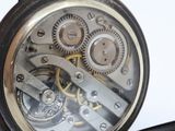 a close up of a pocket watch being held by a person