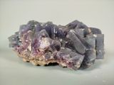 purple crystals on a white surface with a white background