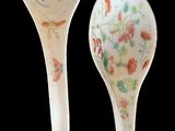 pair of porcelain spoons with birds and flowers painted on them
