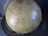 a large globe on a metal stand with a map on it