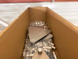 a cardboard box filled with assorted metal parts