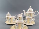 four cups and saucers with saucers and saucers on a table