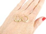 a woman ' s hand with two gold rings on it