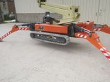 a crane that is sitting on the ground in front of a building