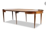 an oval dining table with a glass top and wooden legs