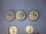 four different types of brass buttons are shown on a blue surface