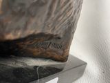 a statue of an owl that is sitting on top of a table