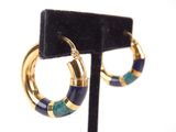 a close up of a pair of hoop earrings on a stand