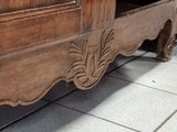 an old wooden bed with a drawer underneath it