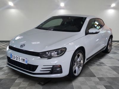 the white volkswagen sciroad is parked on a checkered tile floor