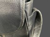 the back of a black purse with a metal clasp on it