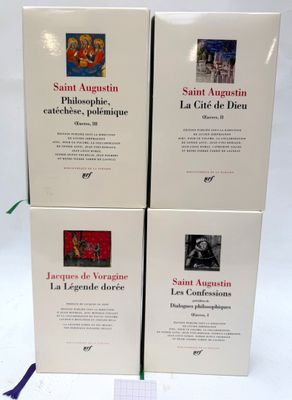 three books on a white table with a blue ribbon on it