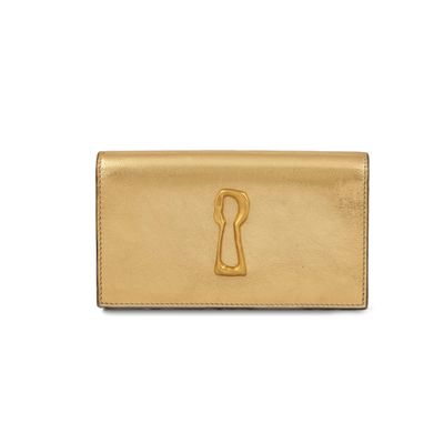 a gold leather wallet with a keyhole on the front