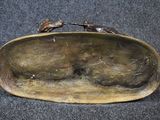 a bronze sculpture of a cat sitting on a plate