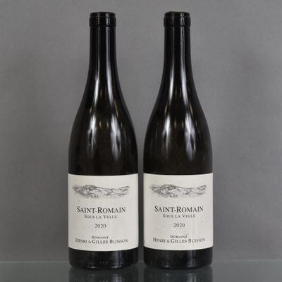 two bottles of wine sitting on top of a table next to each other