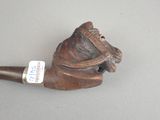 a pipe with a horse head on it on a table