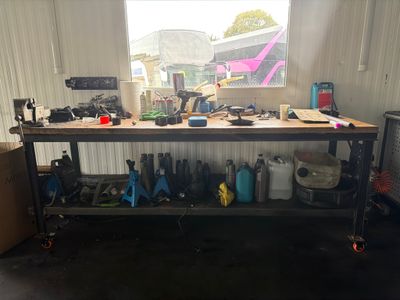 a workbench in a garage with a lot of tools on it