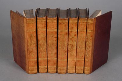several old books are stacked on top of each other on a table