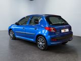 the back of a small blue car parked in a garage