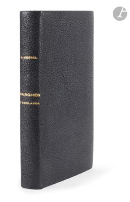 a black leather book with gold trim and a black cover