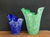 two vases that are sitting on a wooden table