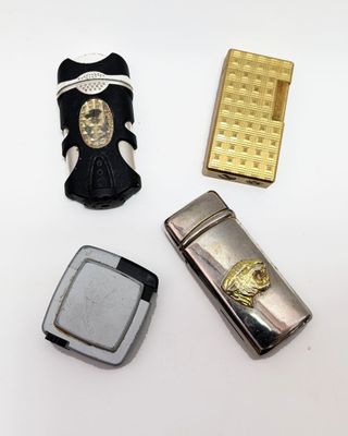 three lighters and a lighter case sitting on a table