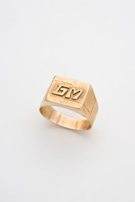 a gold signet ring with the word yes on it