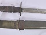 two knives that are laying next to each other on a table