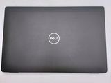 the dell laptop is sitting on a table with its lid open