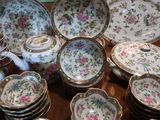 many plates and bowls on a table with a teapot