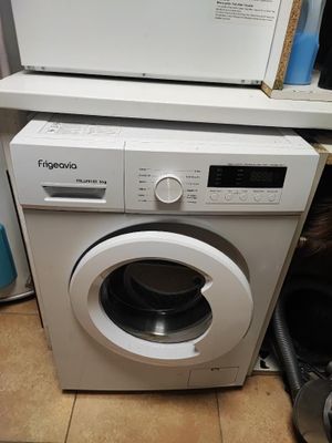 a white washing machine sitting on top of a kitchen counter