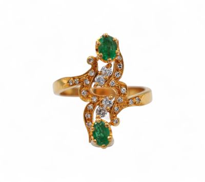 an image of a gold ring with emerald stones and diamonds