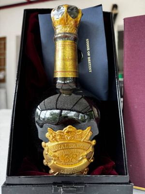 a bottle of liquor that is in a box on a table