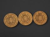 three gold coins, one of which has a coat of arms and the other of which is a coat of