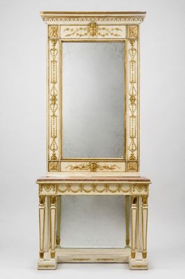 une photo d'un miroir blanc et doré posé sur une table en bois