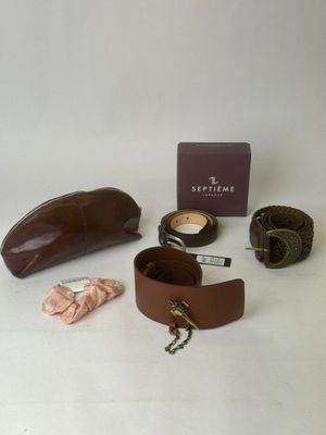 brown leather belt and accessories on a white background