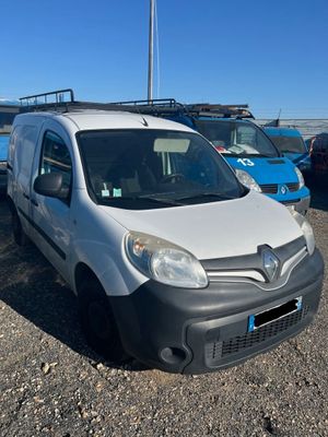 the white van is parked in a lot with other cars