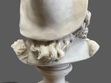 marble bust of a man with a hat on a pedestal