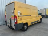 a yellow van that is parked in a parking lot