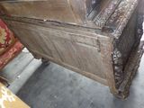 a very old wooden bed that is in the middle of a room