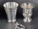 three silver vases and a ring on a table