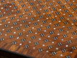a close up of a wooden table with a pattern on it