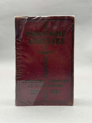un vieux livre posé sur une table à côté d'une tasse