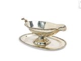 a silver plate with a silver saucer on it