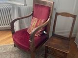 a red chair and a brown chair in a room