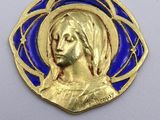 an image of a gold and blue medal with a woman ' s face on it