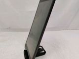 the tablet is sitting on a stand on a white surface