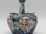 a blue and white vase sitting on a white surface