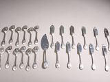 a lot of forks and spoons on the table